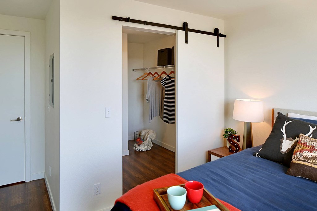 a bedroom with a bed and a closet with a mirror