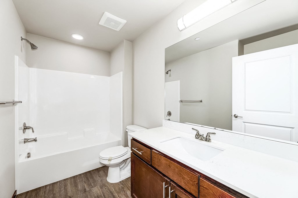 a bathroom with a sink toilet and a mirror