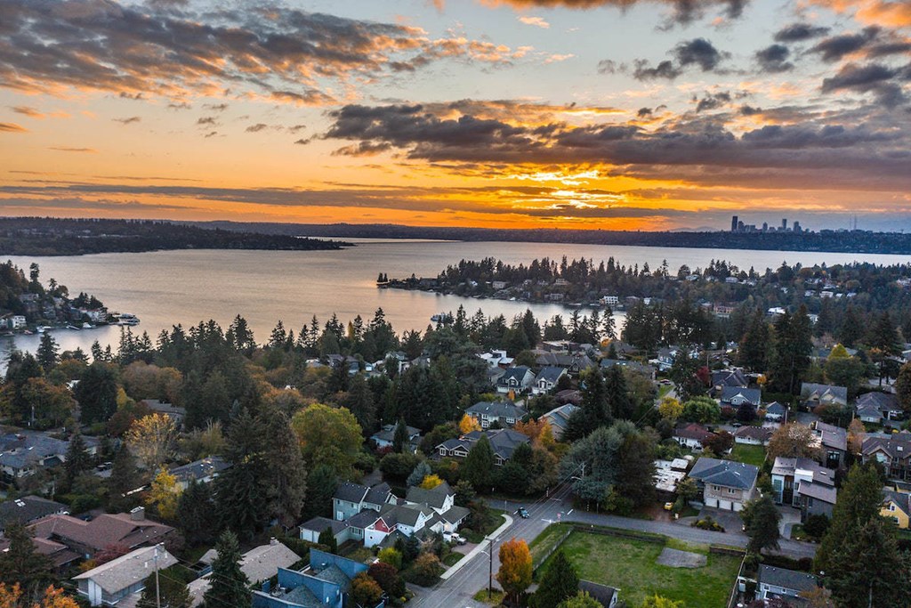 a sunset over a city and a body of water