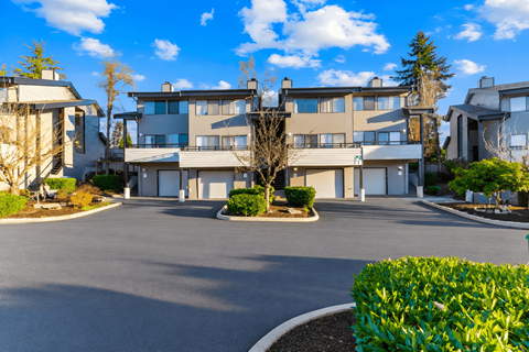 A large building with a driveway in front of it.