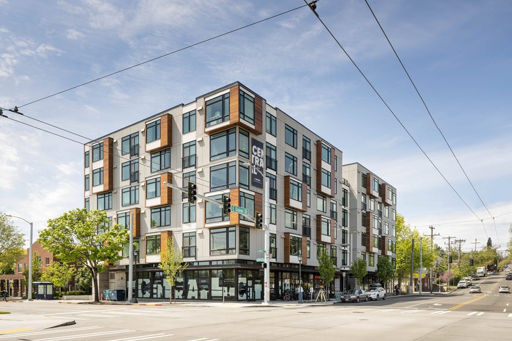 A modern multi-story building with a mix of brown and white exterior.