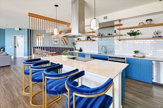 a kitchen with blue bar stools and a white counter top