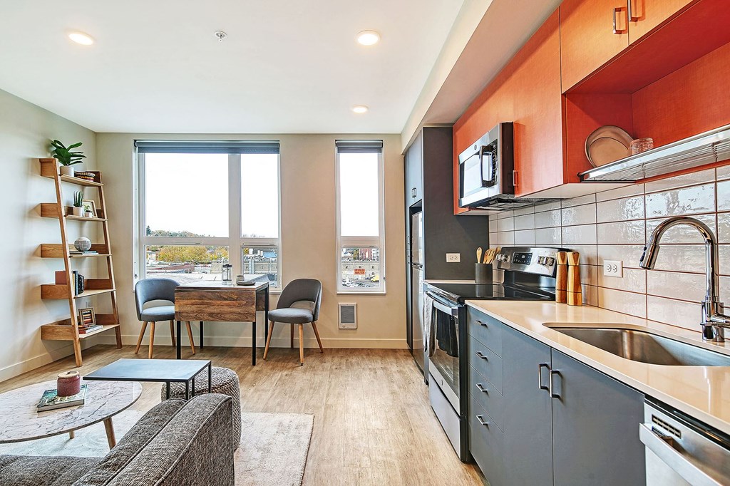 a kitchen and living room with a table and chairs