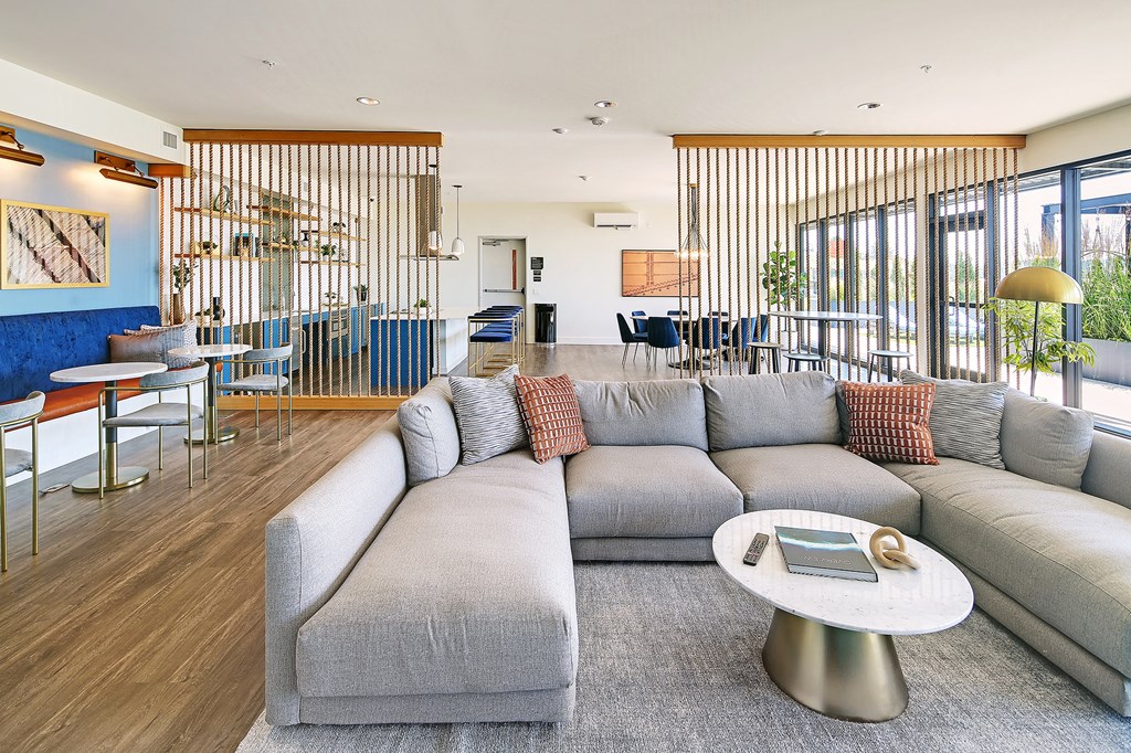 a living room with a gray couch and a coffee table