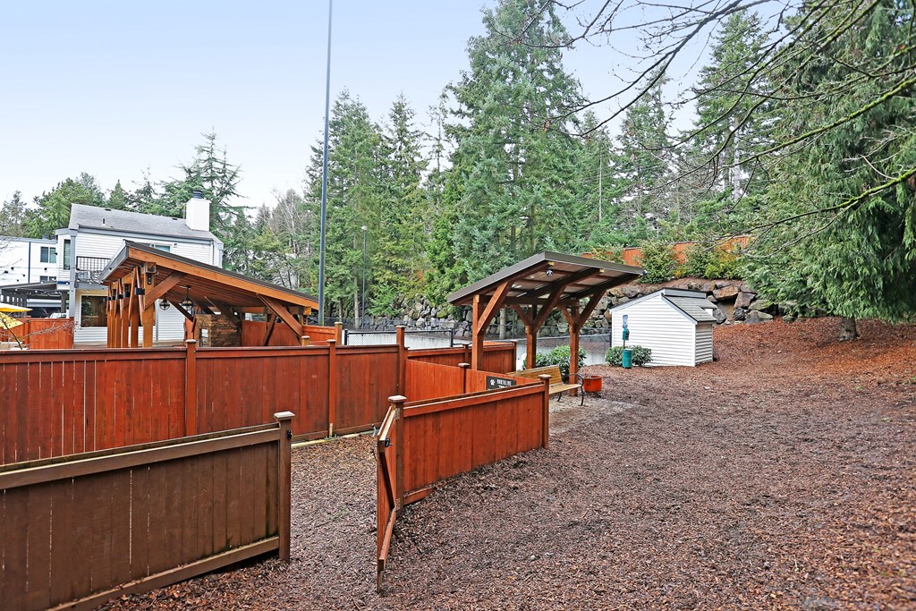 a fenced in area with a wooden fence and benches