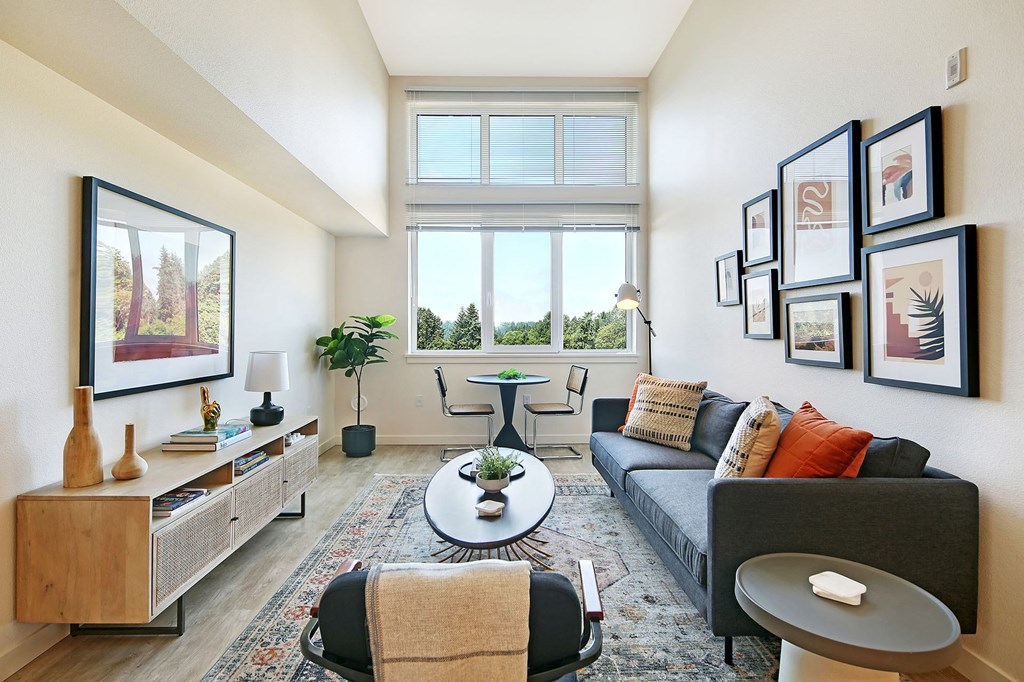 a living room with a couch and a table and a window