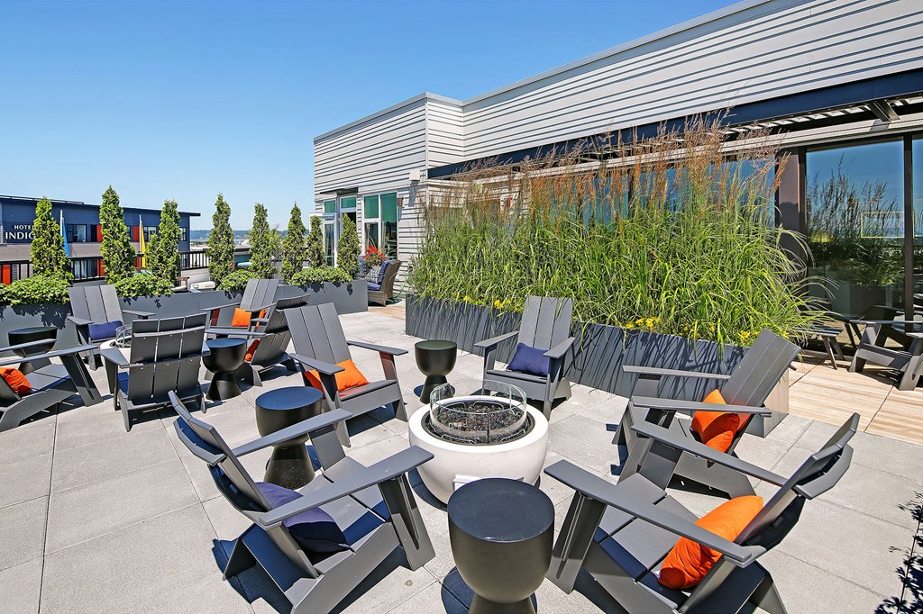 an outdoor patio with chairs and a fire pit