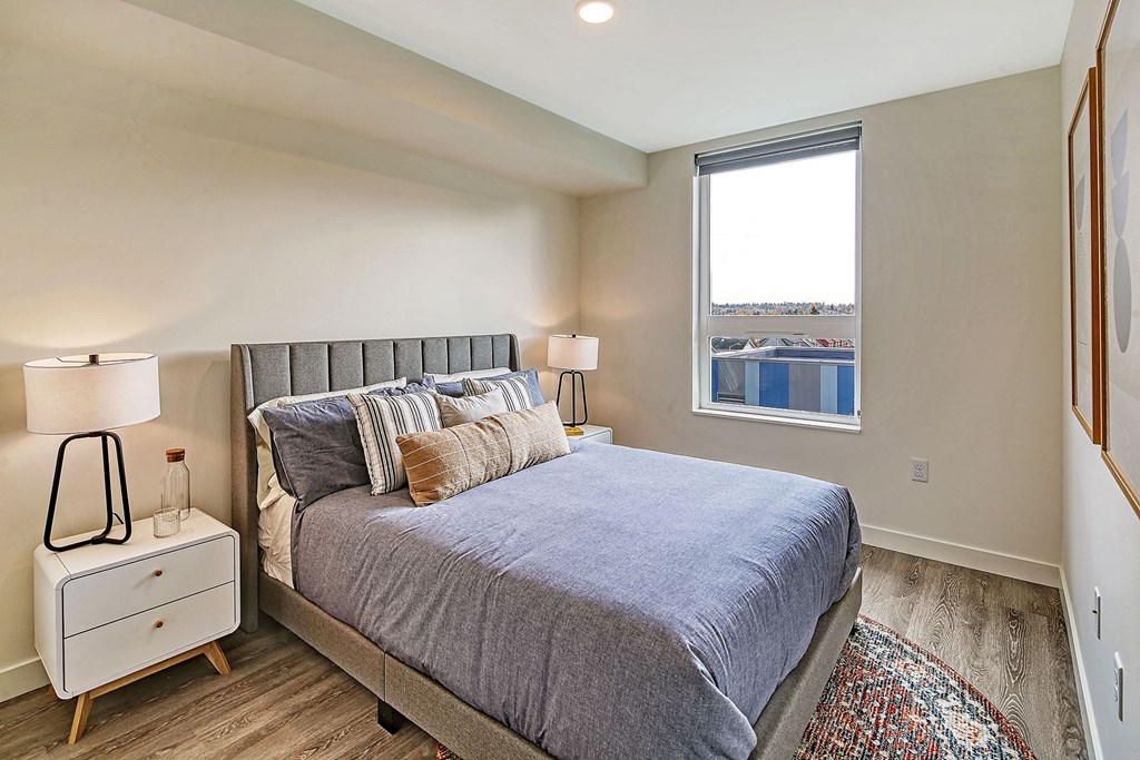 a bedroom with a bed and a window