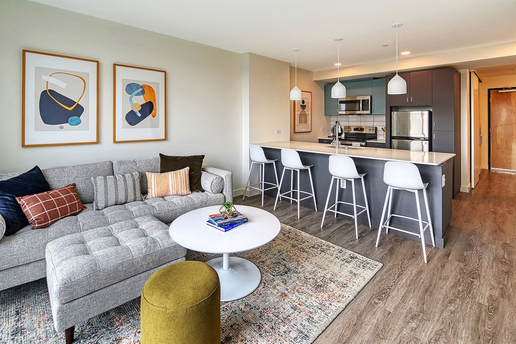 a living room and kitchen with a couch and a table