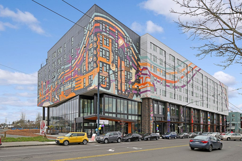 a large building with graffiti on it on a city street