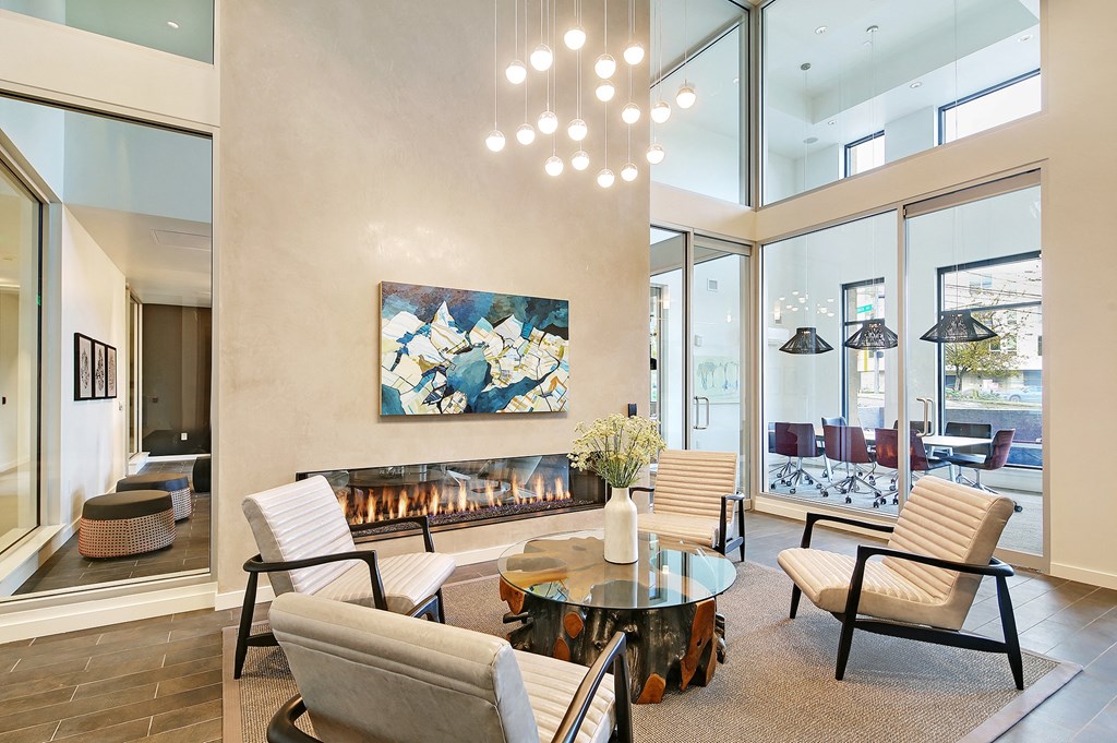 a living room with a fireplace and a table and chairs