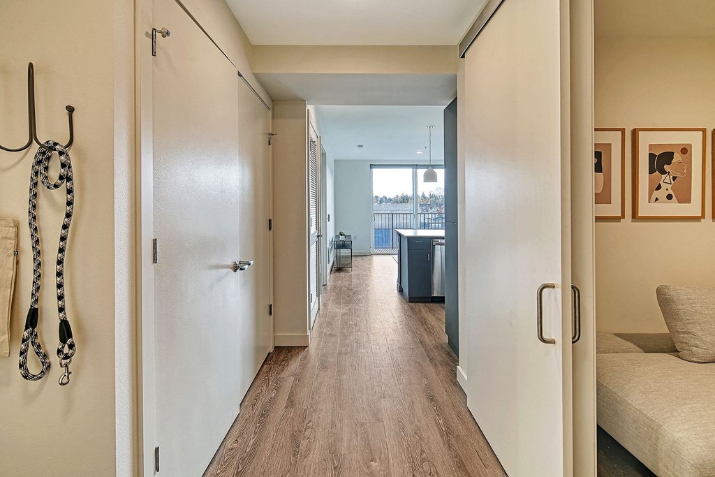 a hallway with a couch and a door to a living room
