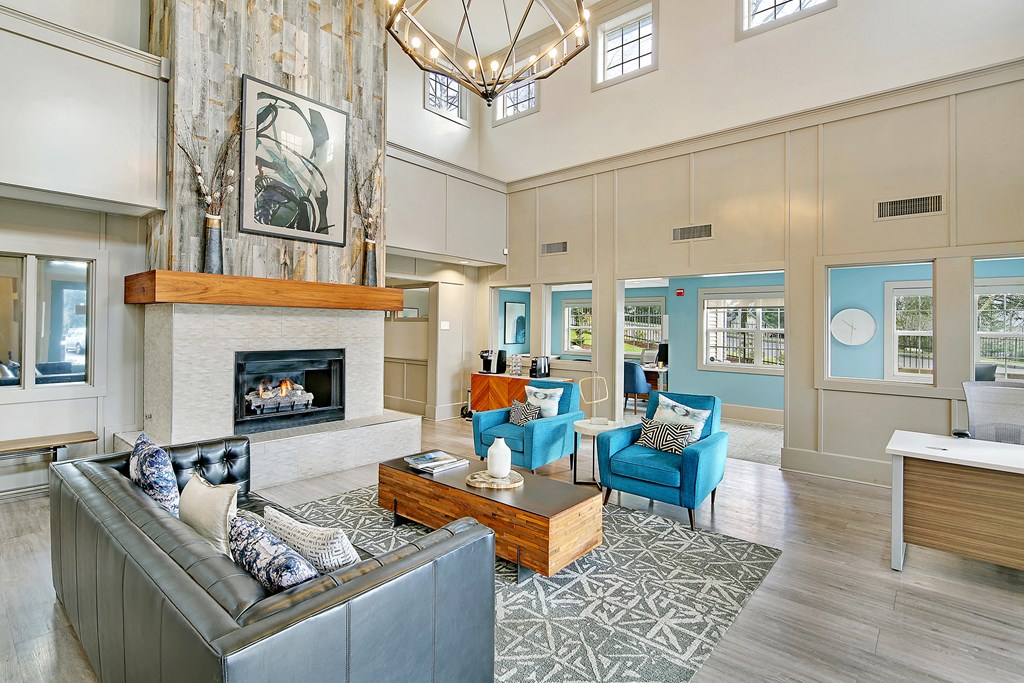 a large living room with a fireplace and blue furniture