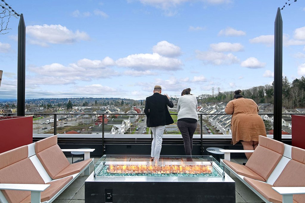 a group of people standing on a balcony overlooking a city