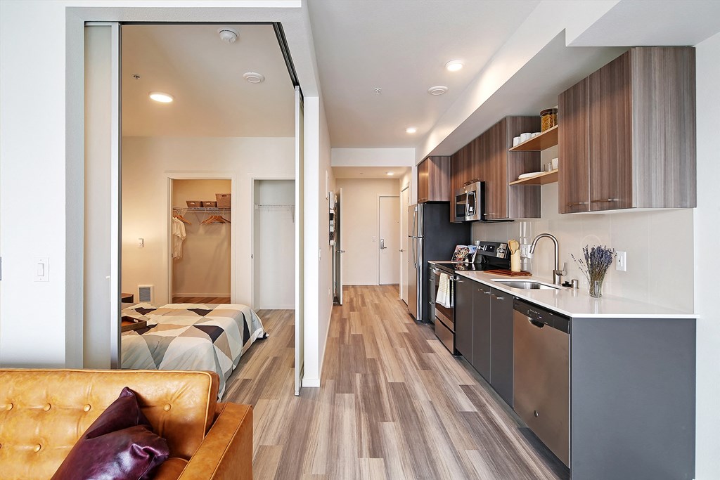 a renovated apartment with a kitchen and a living room