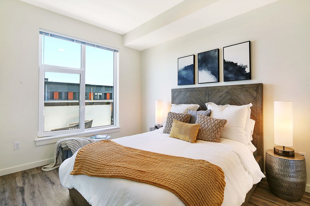 a bedroom with a large bed and a window