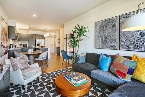 A living room with a grey couch and a wooden coffee table.