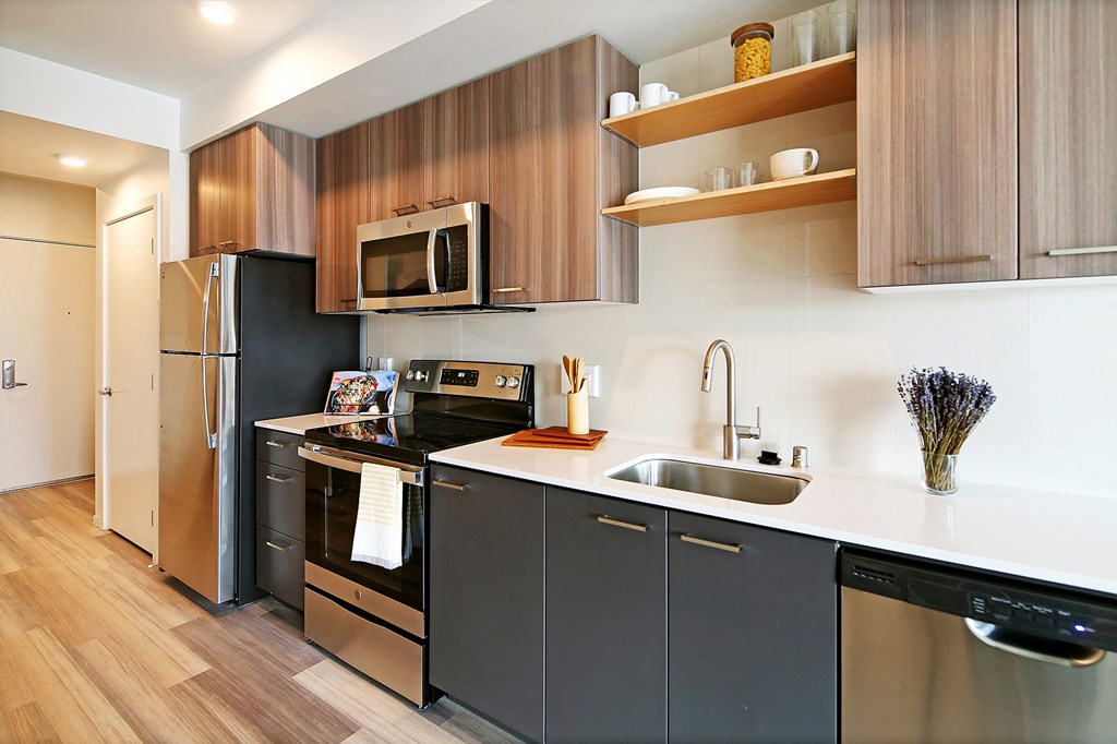 a kitchen with stainless steel appliances and wooden cabinets