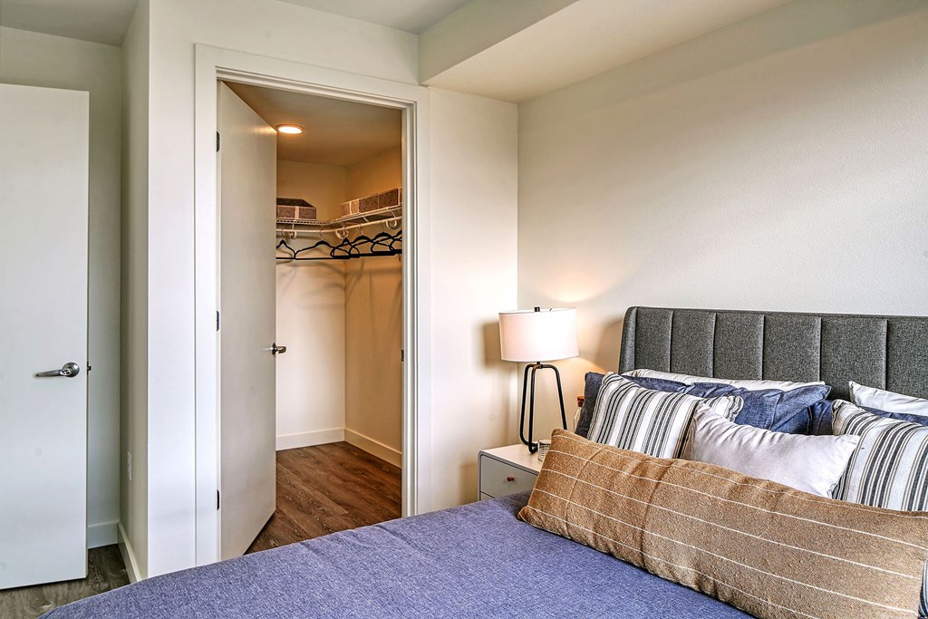 a bedroom with a bed and a door to a closet