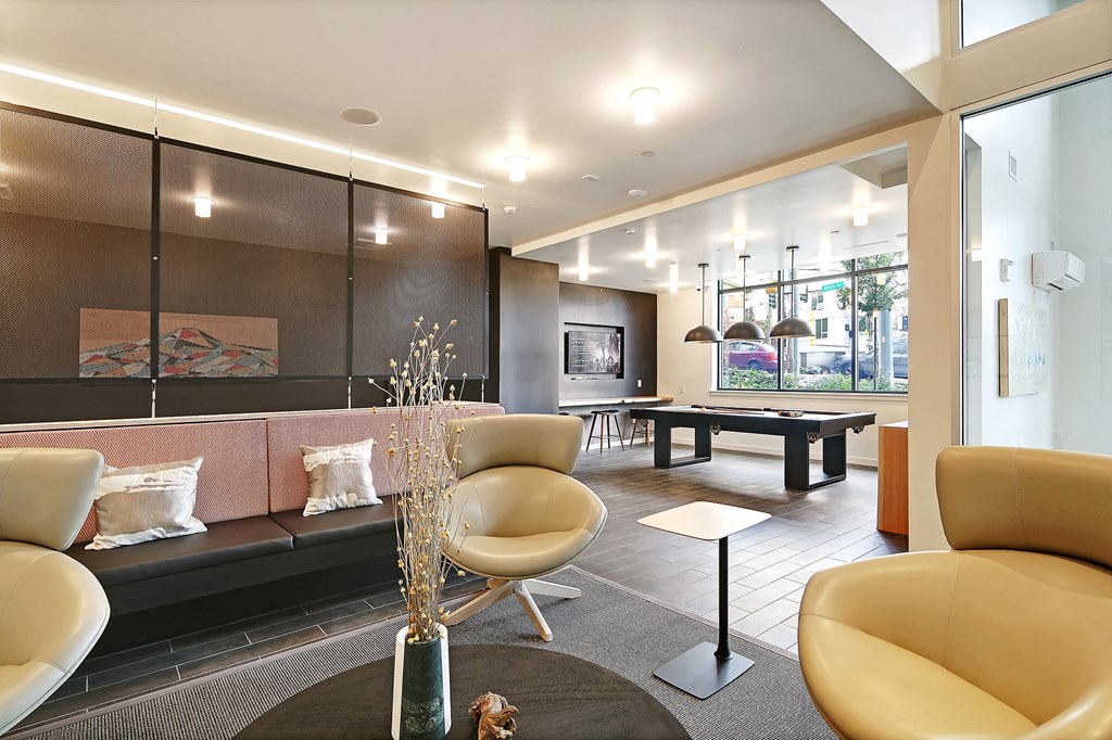 a living room with furniture and a ping pong table