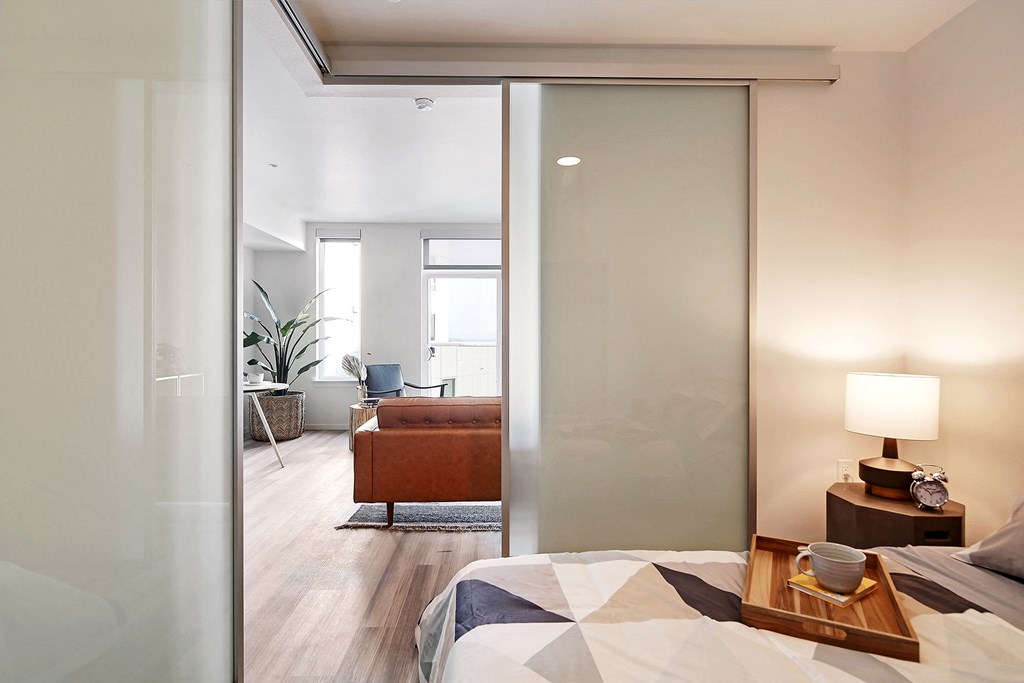 a bedroom with a bed and a sliding glass door