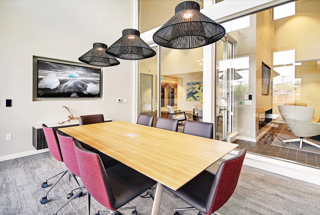 a conference room with a wooden table and chairs