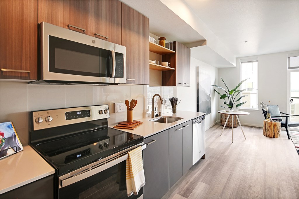 a kitchen with stainless steel appliances and wooden cabinets