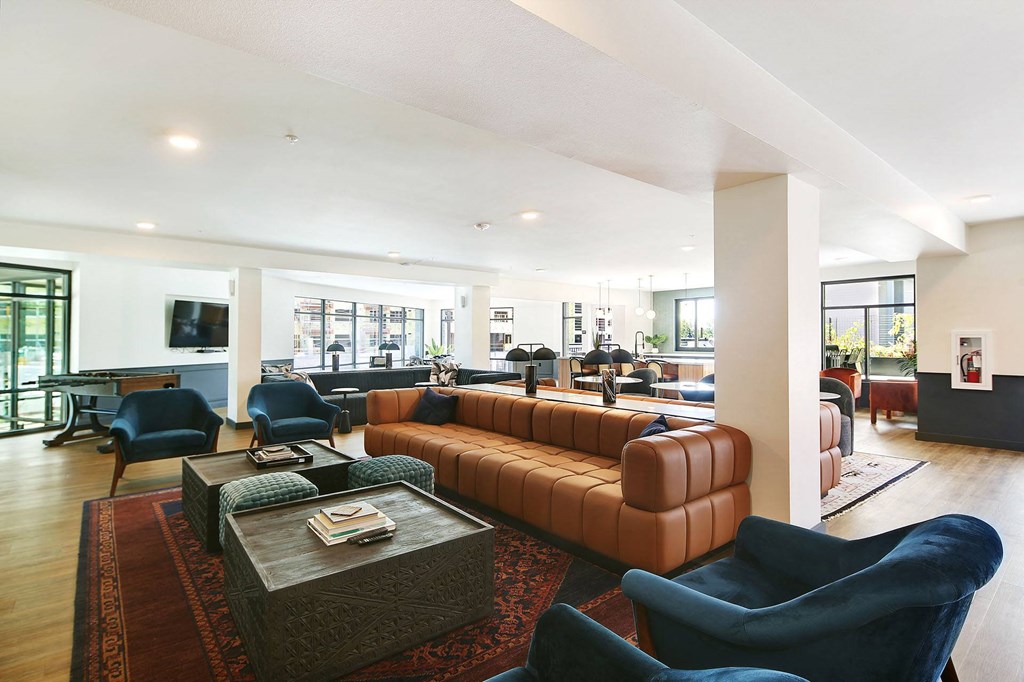 a large living room with leather couches and chairs