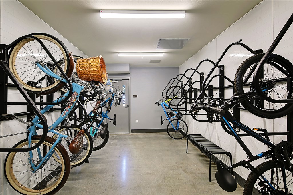 a row of bikes hanging on a wall in a building