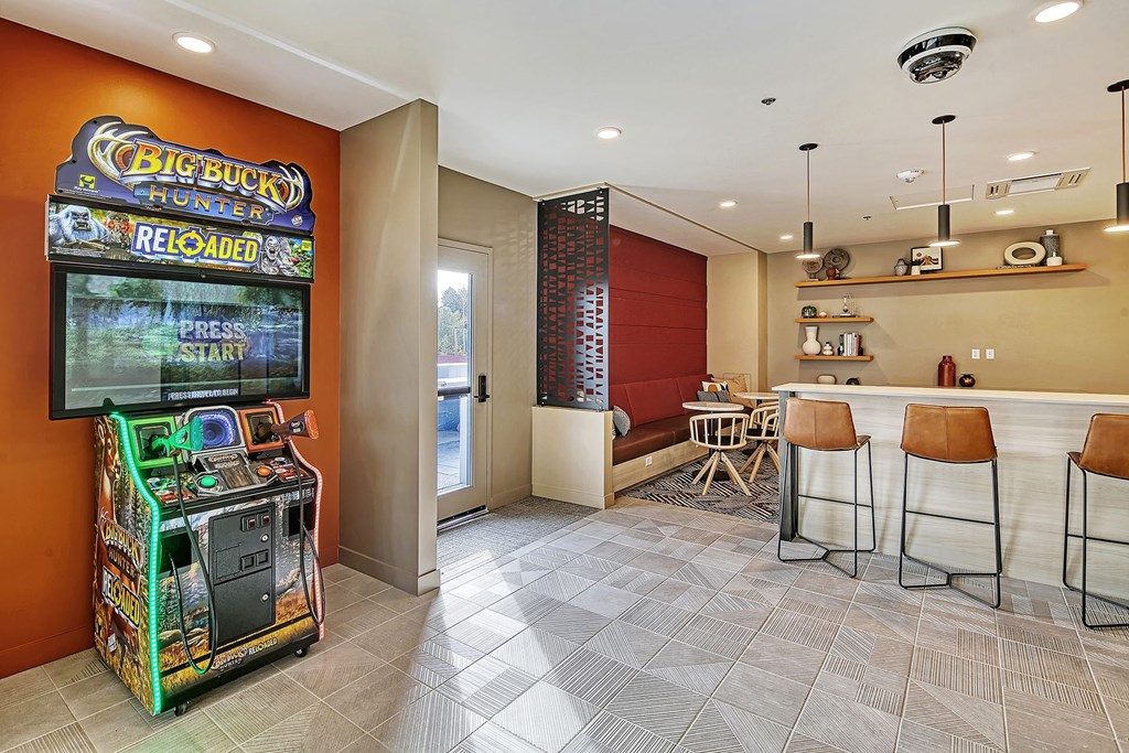a game room with a bar and a slot machine