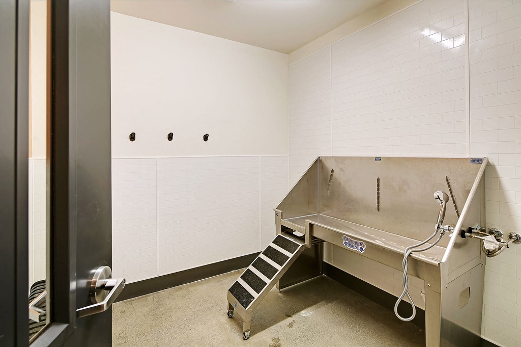 a commercial kitchen with a stainless steel stove and a sink