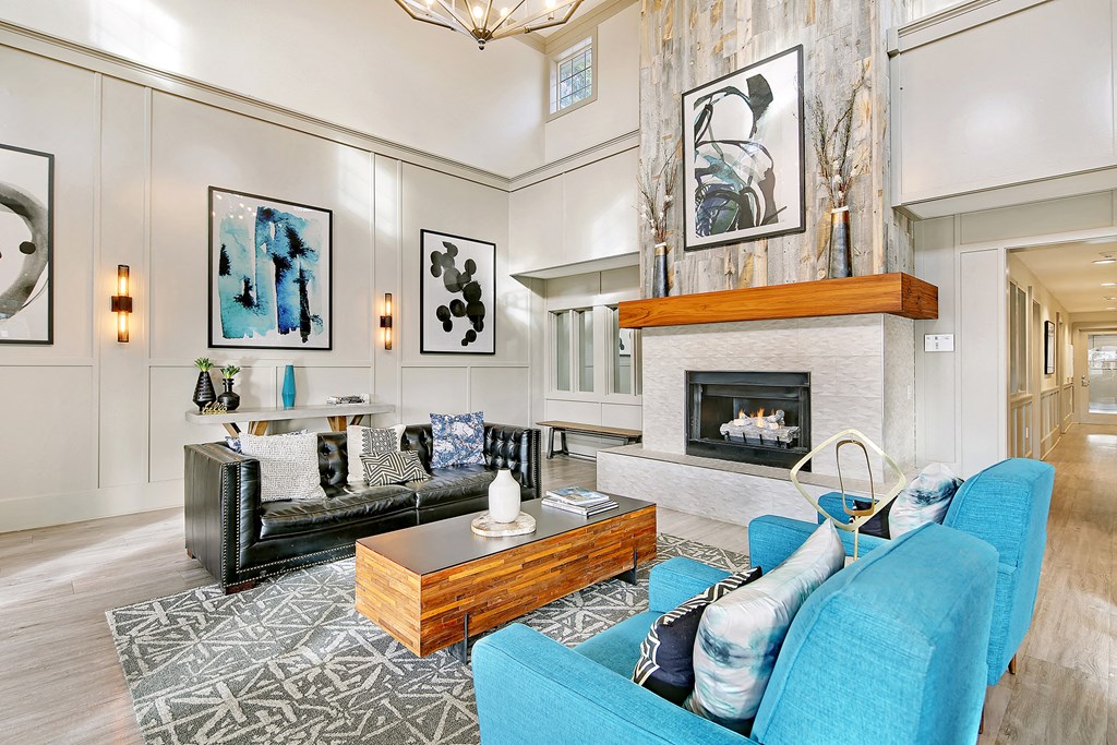 a living room with blue furniture and a fireplace