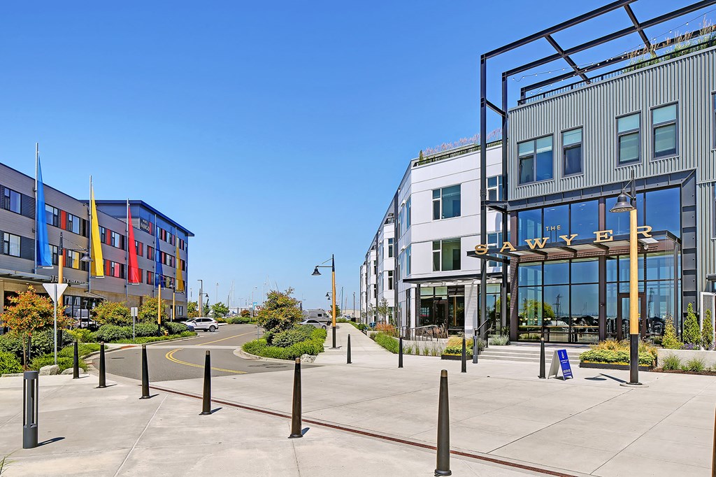 a city street with buildings and a sidewalk