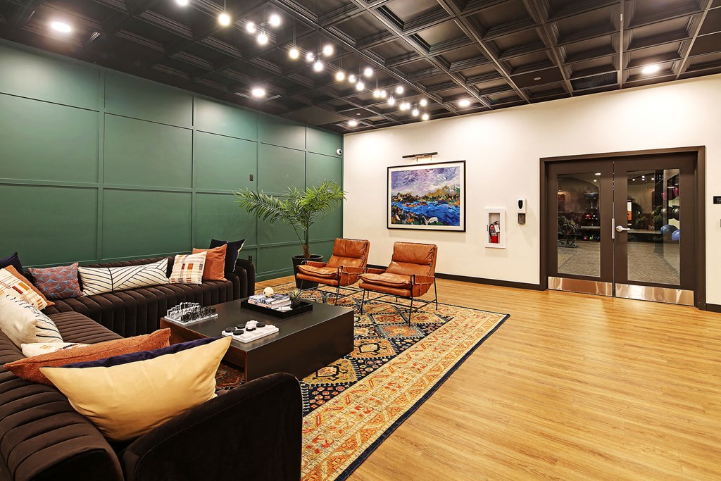 a living room with leather furniture and a rug