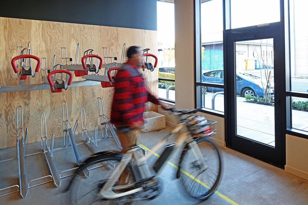 a man is walking a bike through a lobby