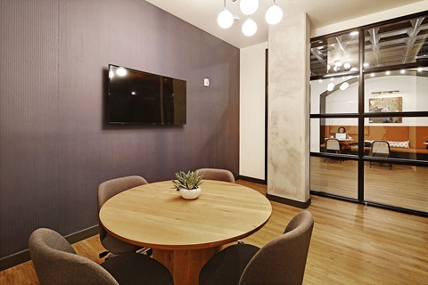 a conference room with a round table and a tv