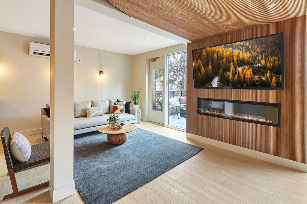 a living room with a couch and a coffee table in front of a fireplace