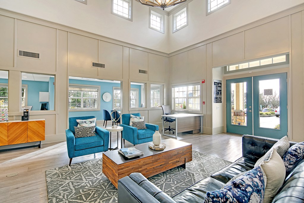 a living room with blue couches and chairs and a coffee table