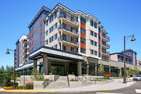 a large building with stairs and a street in front of it