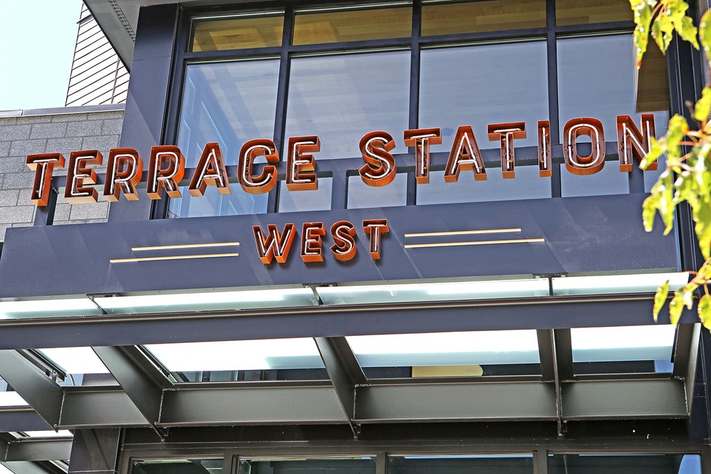 a sign for terrace station west on the side of a building