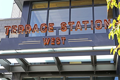 a sign for terrace station west on the side of a building