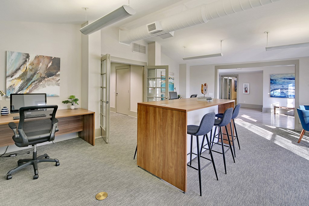 a conference room with a bar and a desk with chairs