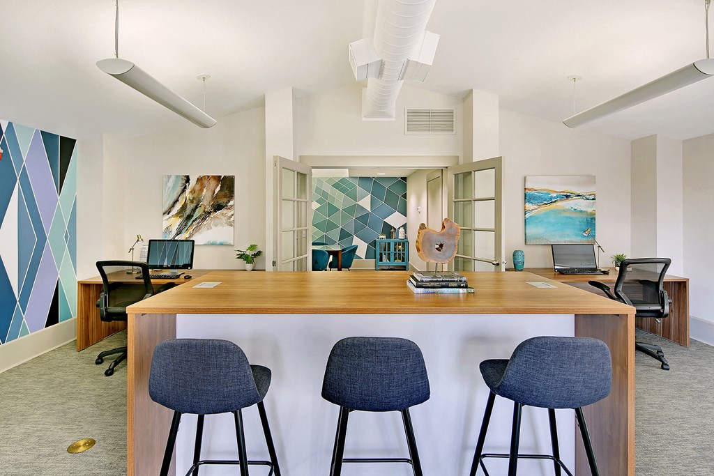 a kitchen with a bar and four blue stools