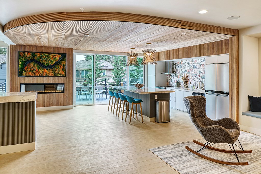a living room with a kitchen and a balcony