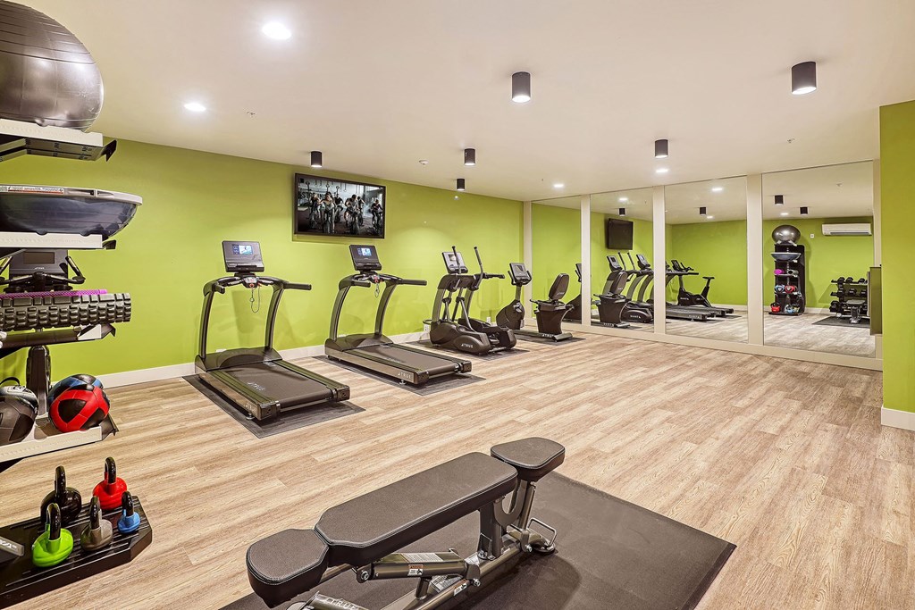 a gym with treadmills and other exercise equipment