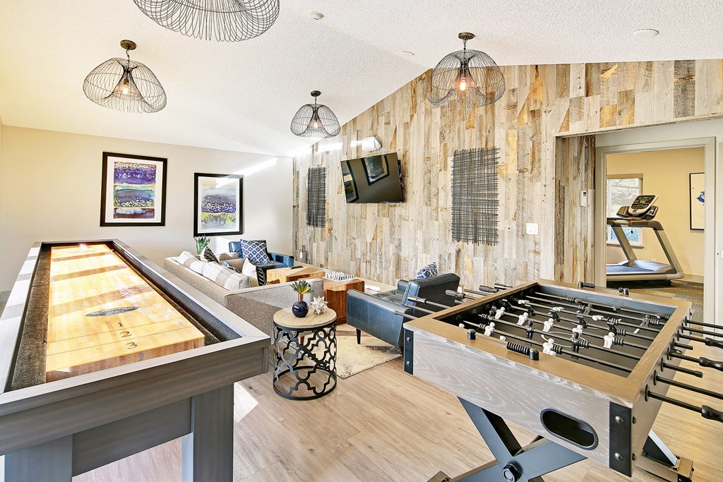 a game room with a foosball table and a pool table