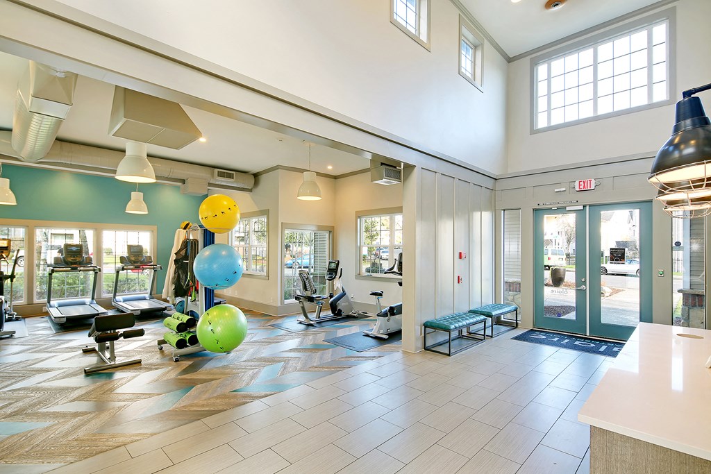 a large lobby with a bunch of chairs and balloons