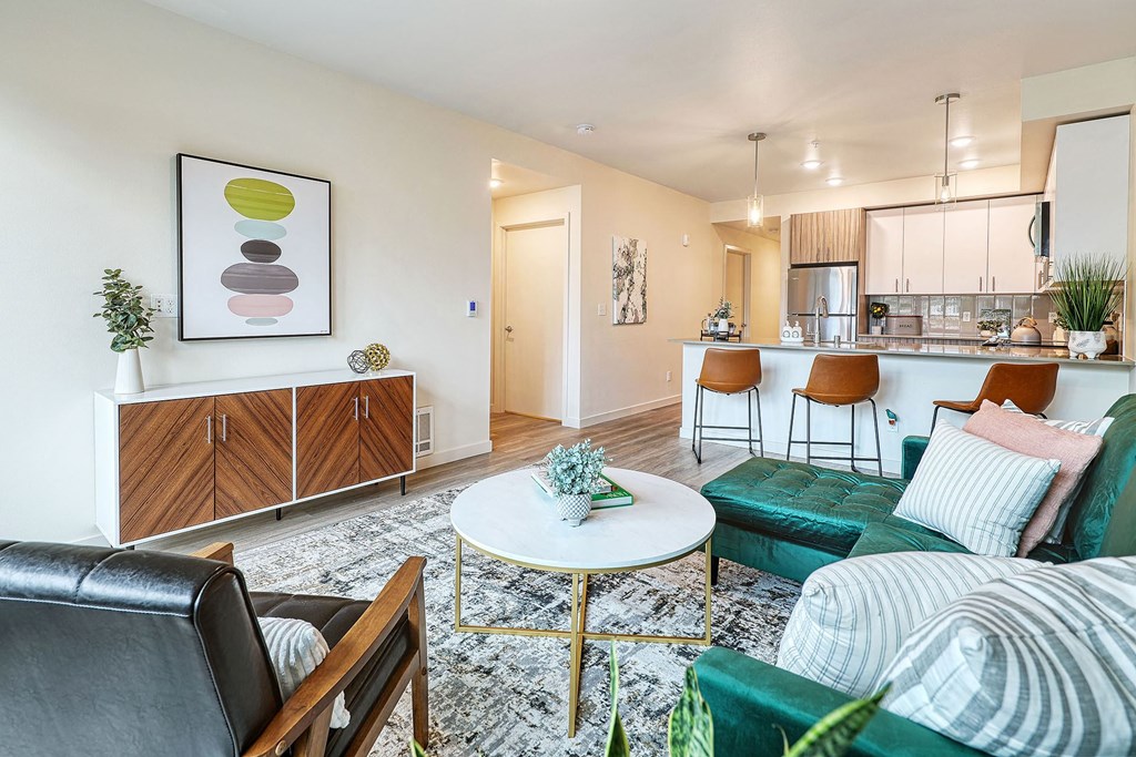 a living room with a green couch and a white coffee table