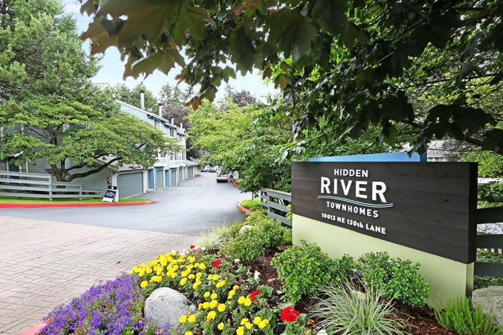 a sign for hidalgo river townships with flowers and trees