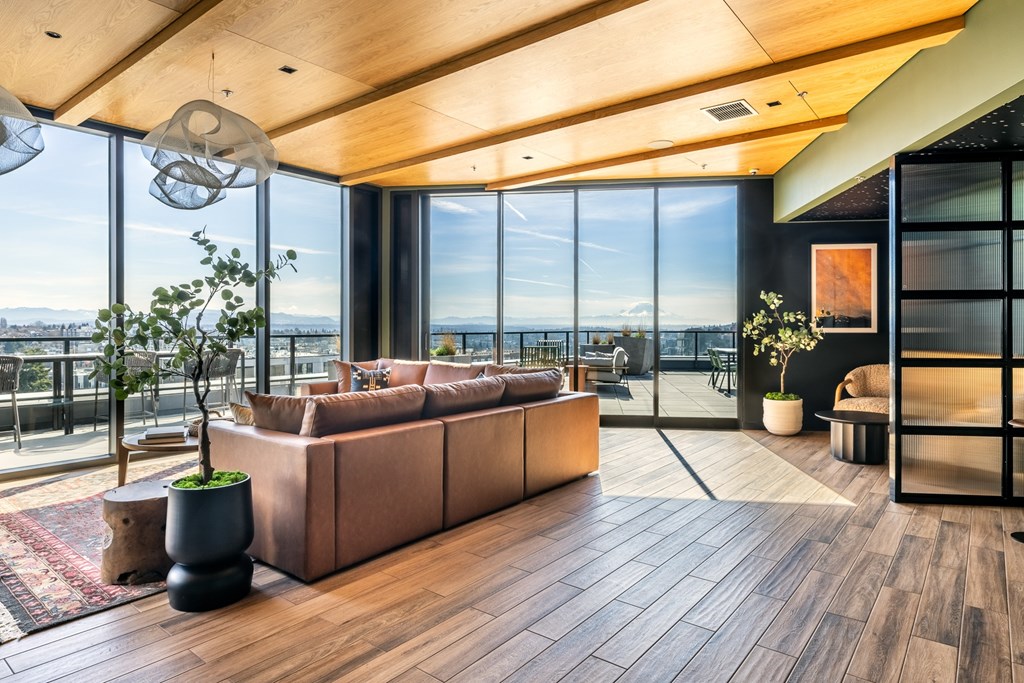 A modern living room with a large window overlooking the ocean.